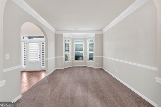 unfurnished dining area with coffered ceiling, an inviting chandelier, ornamental molding, beam ceiling, and carpet