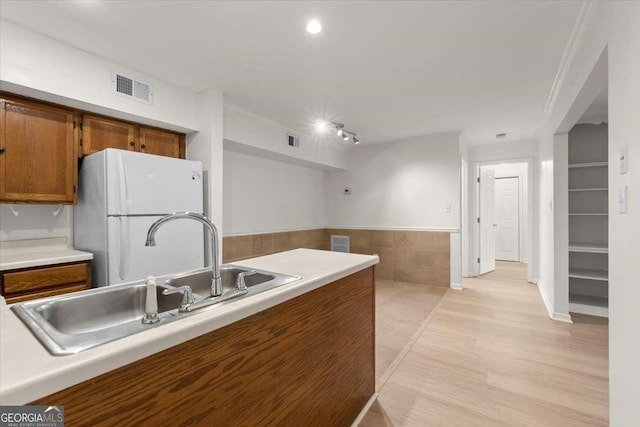 kitchen featuring sink and white refrigerator