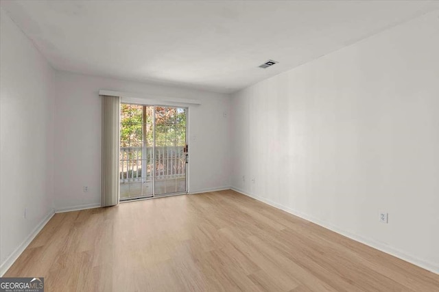 unfurnished room with light hardwood / wood-style floors