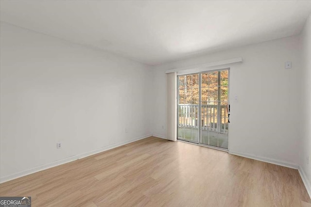 spare room with light hardwood / wood-style flooring