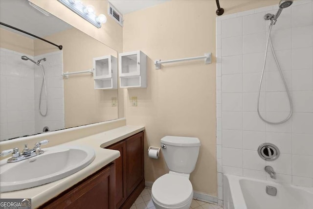 full bathroom with tile patterned floors, vanity, toilet, and tiled shower / bath combo