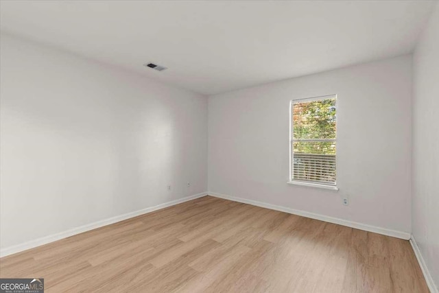 spare room with light hardwood / wood-style flooring