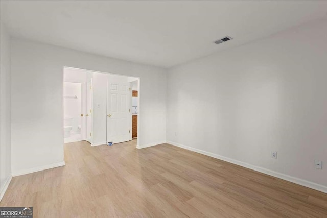 spare room with light wood-type flooring