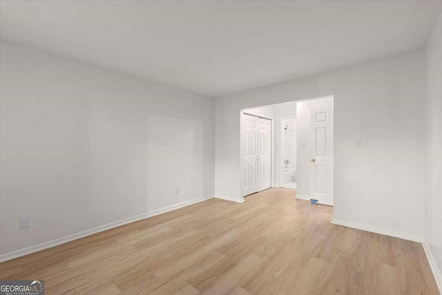 empty room with light hardwood / wood-style floors