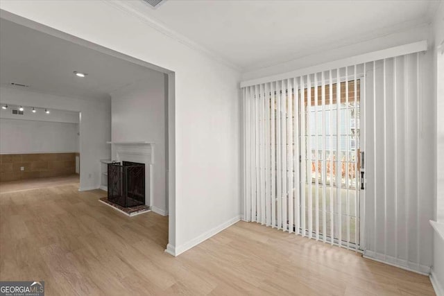 interior space featuring ornamental molding and hardwood / wood-style floors