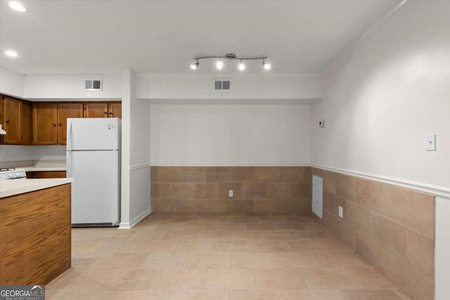 kitchen featuring light tile patterned flooring and white fridge