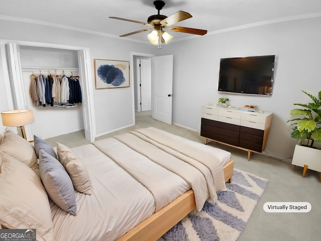 bedroom with ceiling fan, light colored carpet, a closet, and ornamental molding