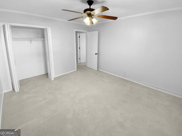 unfurnished bedroom featuring ceiling fan, light carpet, a closet, and ornamental molding