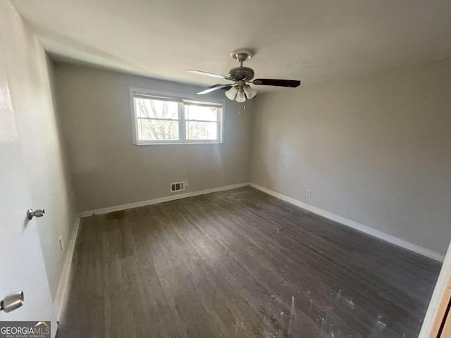 spare room with ceiling fan and dark hardwood / wood-style flooring