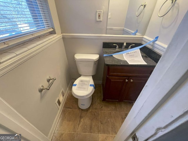 bathroom featuring toilet and vanity