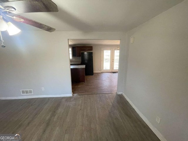 interior space with ceiling fan, dark hardwood / wood-style flooring, and french doors