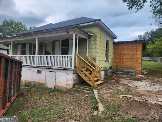 view of side of property with covered porch