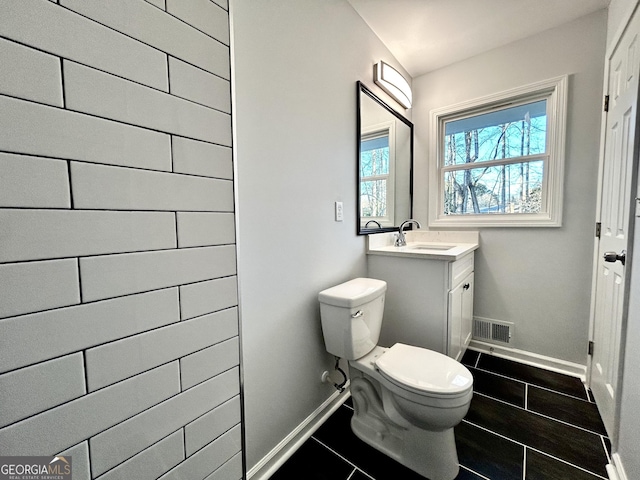 bathroom with toilet and vanity