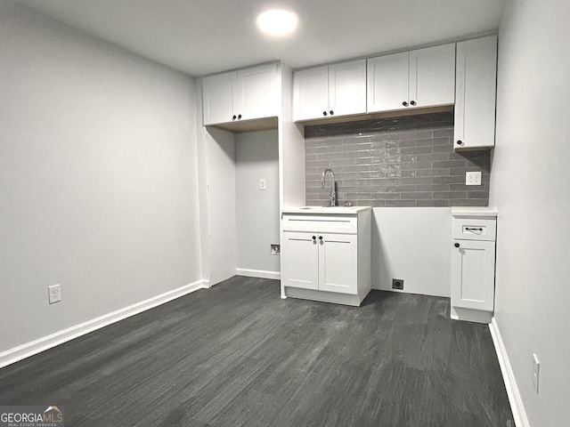 clothes washing area with sink and dark hardwood / wood-style floors