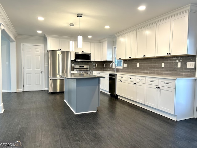 kitchen with white cabinetry, appliances with stainless steel finishes, decorative light fixtures, dark wood-type flooring, and a kitchen island