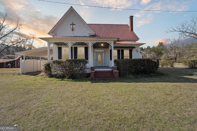 view of front of home featuring covered porch and a lawn