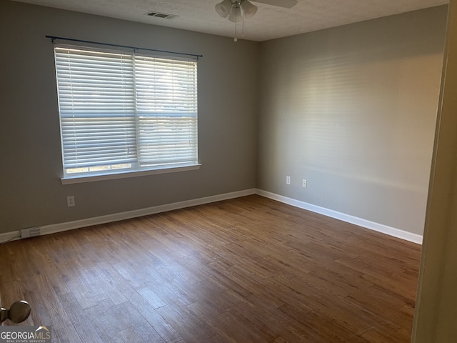 unfurnished room featuring a textured ceiling, ceiling fan, and wood-type flooring