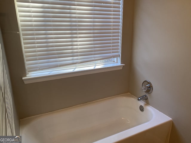 bathroom with a tub to relax in