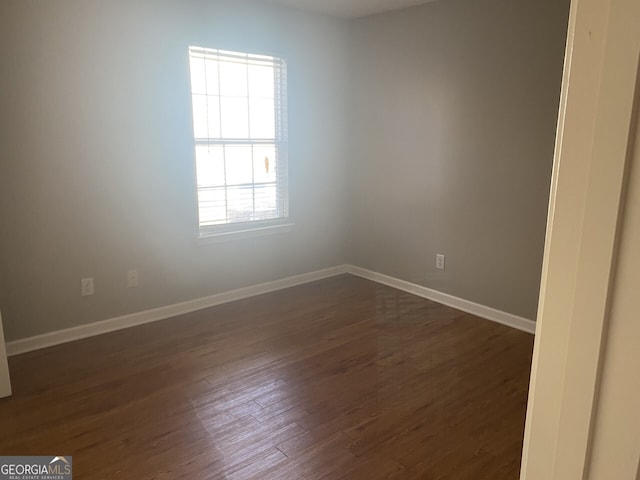 spare room with dark hardwood / wood-style floors