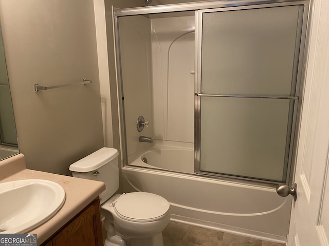 full bathroom with bath / shower combo with glass door, toilet, and vanity