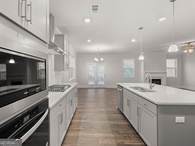 42 Parkview Dr, Dallas, GA 30157 - kitchen with stainless steel appliances, an island with sink, sink, hanging light fixtures, and ventilation hood