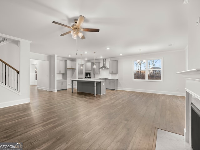 42 Parkview Dr, Dallas, GA 30157 - unfurnished living room with a fireplace, ceiling fan with notable chandelier, ornamental molding, and hardwood / wood-style floors