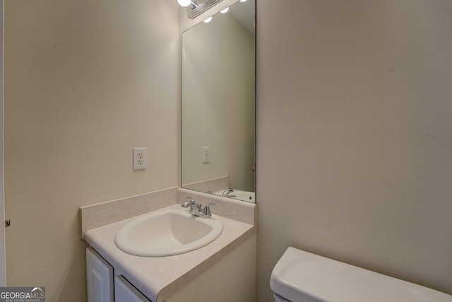 bathroom with toilet and vanity