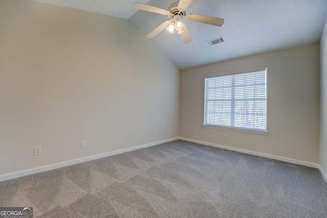 carpeted empty room featuring ceiling fan and vaulted ceiling