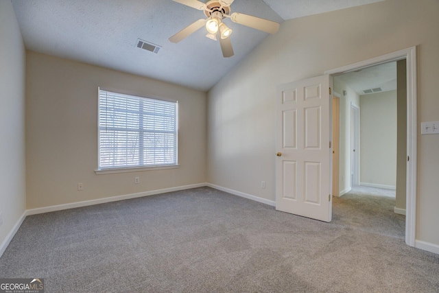 unfurnished room with ceiling fan, light carpet, and vaulted ceiling