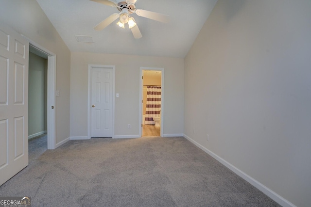 unfurnished bedroom with connected bathroom, ceiling fan, lofted ceiling, and light colored carpet