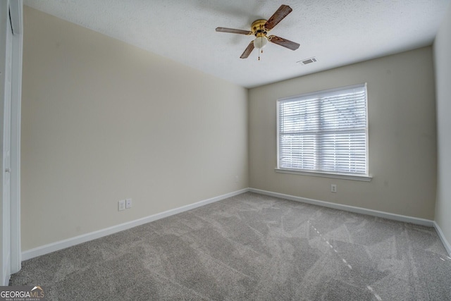 spare room with light carpet and ceiling fan