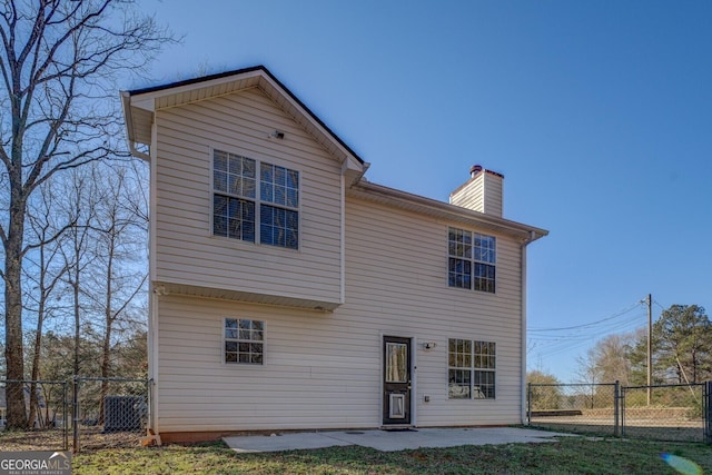 back of property featuring a lawn and a patio