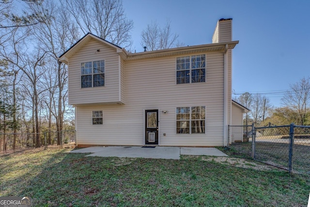 rear view of property with a lawn and a patio