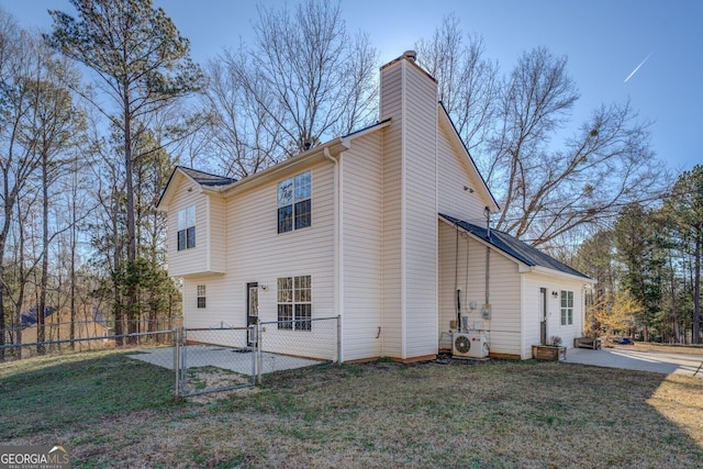 rear view of property with a yard