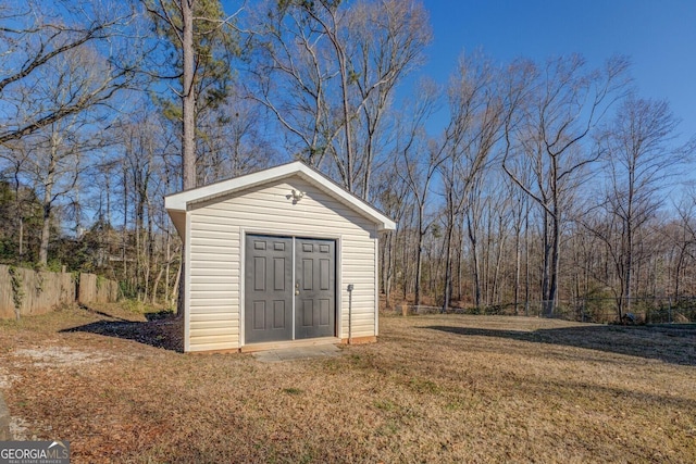 view of outbuilding with a lawn