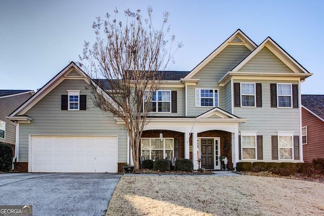 view of front of property with a garage and covered porch