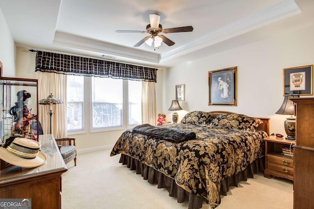 carpeted bedroom featuring ceiling fan, crown molding, and a raised ceiling