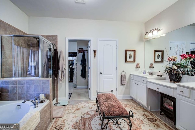 bathroom with shower with separate bathtub and vanity