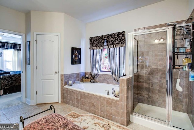 bathroom featuring plenty of natural light, separate shower and tub, and tile patterned flooring