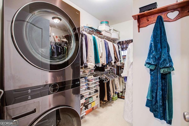 walk in closet featuring stacked washer and clothes dryer