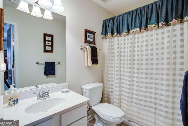 bathroom featuring toilet, a shower with curtain, and vanity