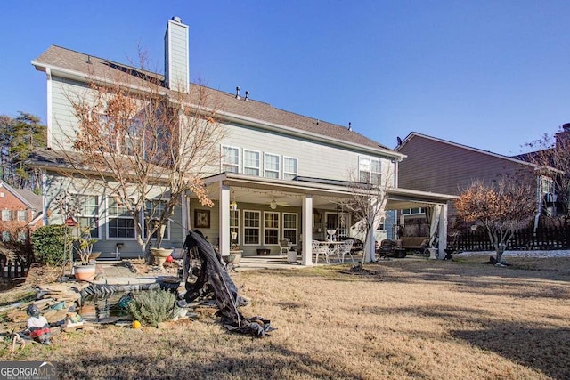 back of house featuring a patio area, a yard, and ceiling fan