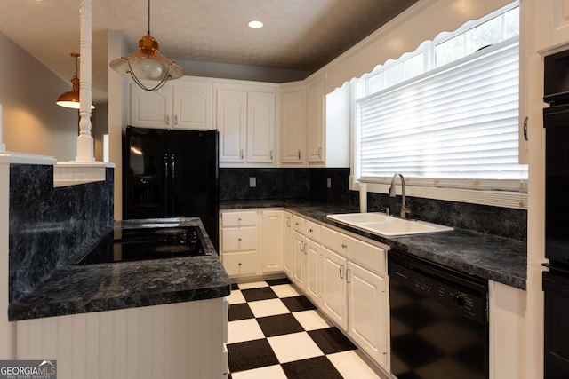 kitchen featuring white cabinetry, sink, pendant lighting, and black appliances