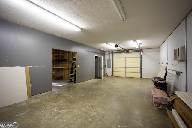 garage with an AC wall unit, a garage door opener, and electric panel