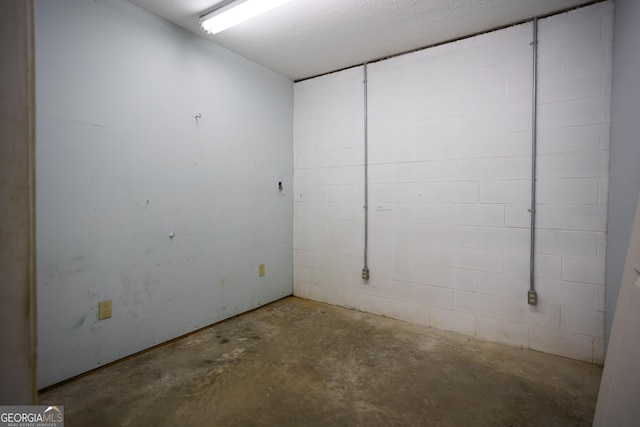 unfurnished room with concrete floors