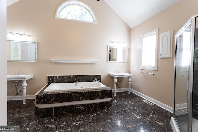 bathroom with independent shower and bath and lofted ceiling