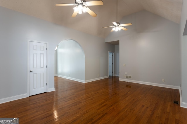 empty room with ceiling fan, dark hardwood / wood-style flooring, and lofted ceiling