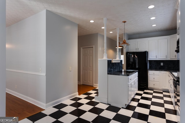 kitchen with decorative light fixtures, tasteful backsplash, black appliances, a textured ceiling, and white cabinets