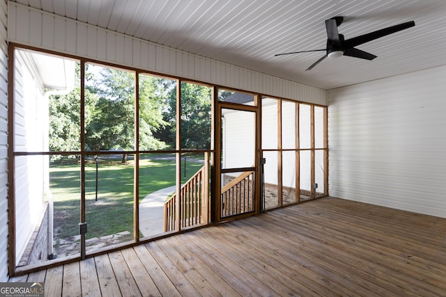 unfurnished sunroom featuring ceiling fan