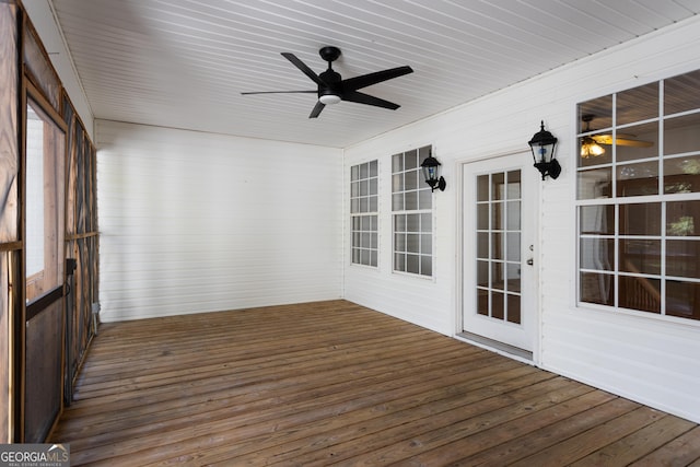 unfurnished sunroom with ceiling fan